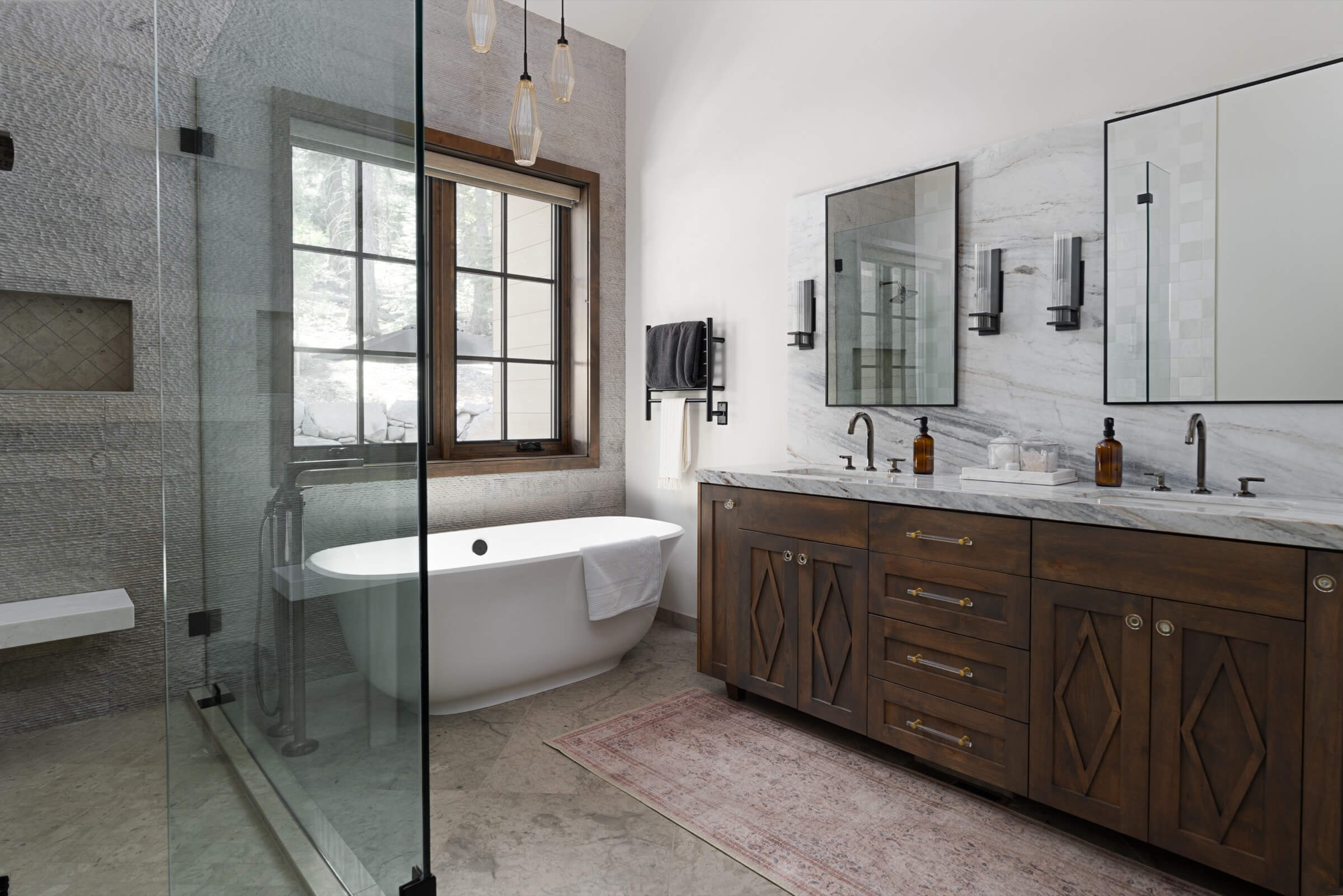 Mountain modern bathroom in Schaffer's Mill with wooden vanity, freestanding bathtub, and large mirrors.