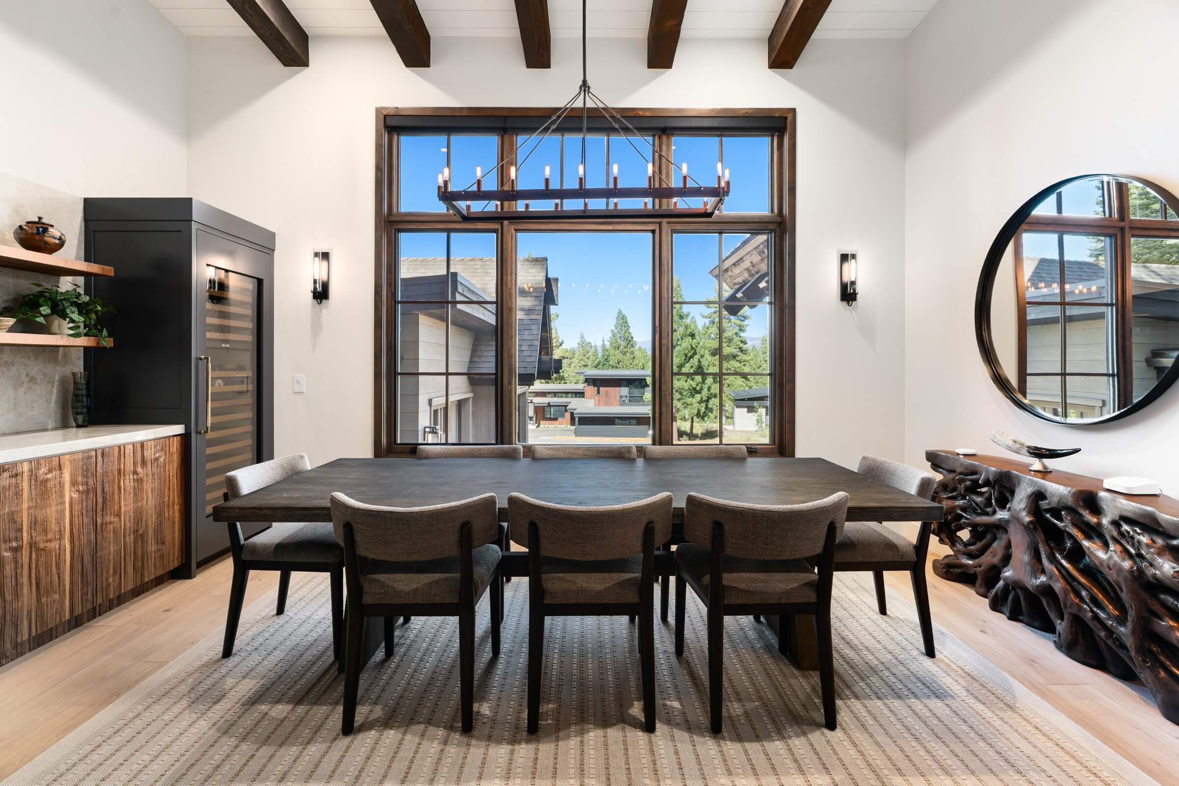 Schaffer's Mill residence with mountain modern dining room with a large window, wooden table, and chairs.